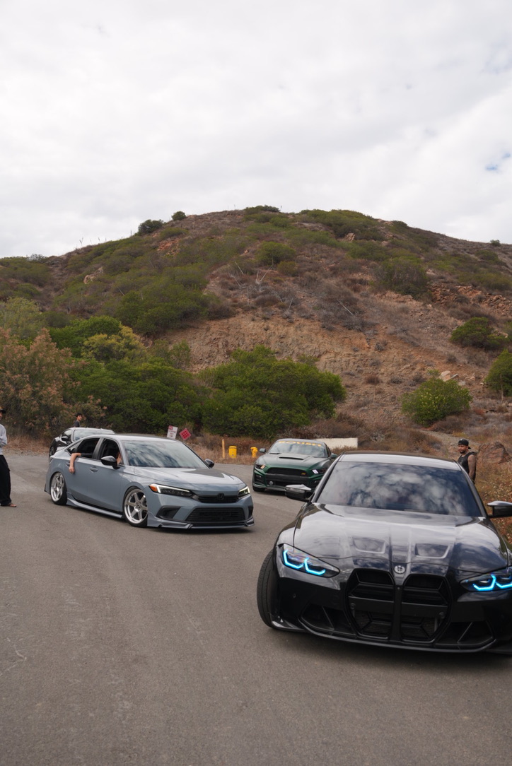 Brayden's BMW M3 leading a lineup on a canyon road